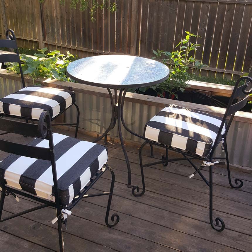 Black and white striped patio chair cushions made with Sunbrella